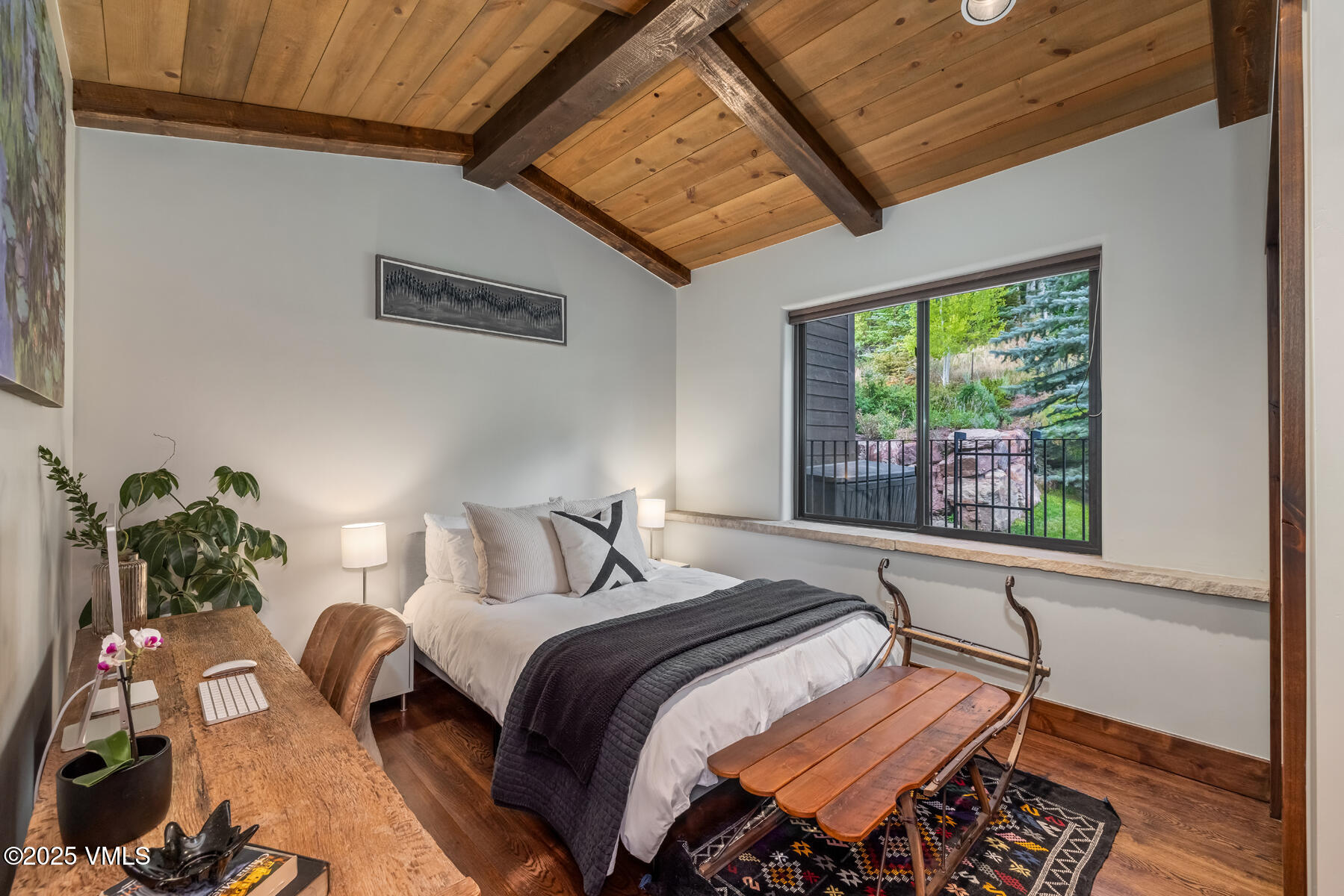 2310 Old Trail Road, Unit A Avon, CO 81620 - Photo 26 of 36 a bedroom with a bed window and a potted plant