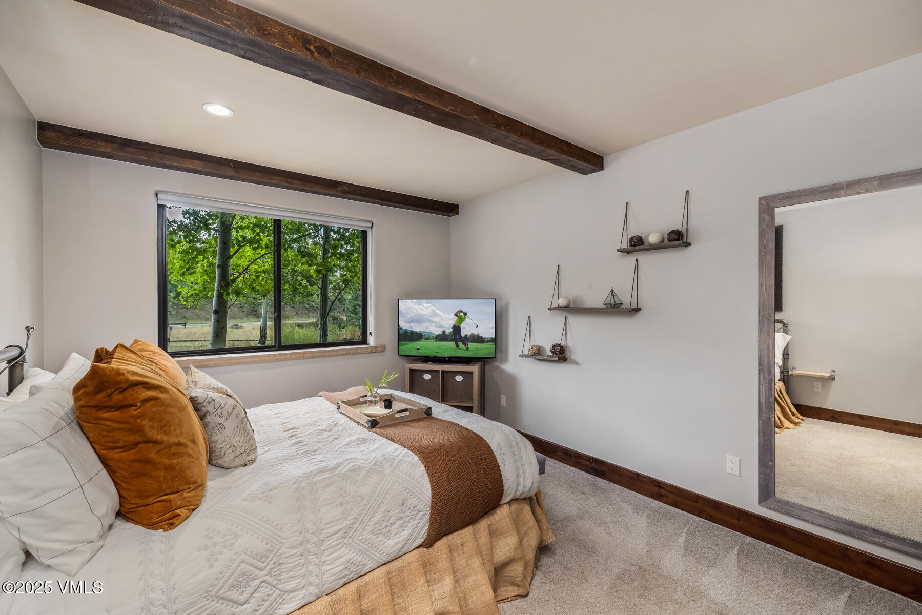 2310 Old Trail Road, Unit A Avon, CO 81620 - Photo 28 of 36 a bedroom with a bed and a large window