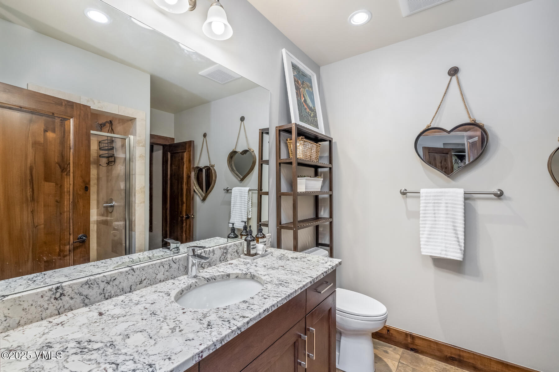 2310 Old Trail Road, Unit A Avon, CO 81620 - Photo 29 of 36 a bathroom with a granite countertop sink a toilet and a mirror