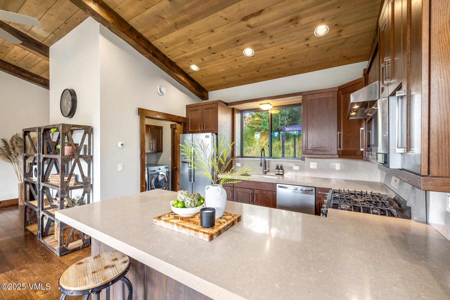 2310 Old Trail Road, Unit A Avon, CO 81620 - Photo 7 of 36 a large living room with large couches chandelier and a dining table with wooden floor
