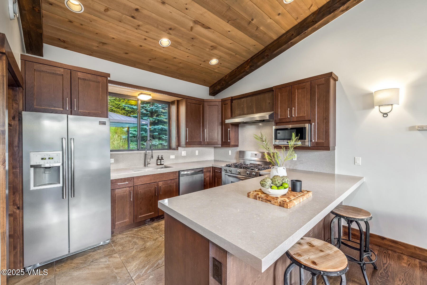 2310 Old Trail Road, Unit A Avon, CO 81620 - Photo 8 of 36 a kitchen with stainless steel appliances granite countertop a sink refrigerator stove and microwave