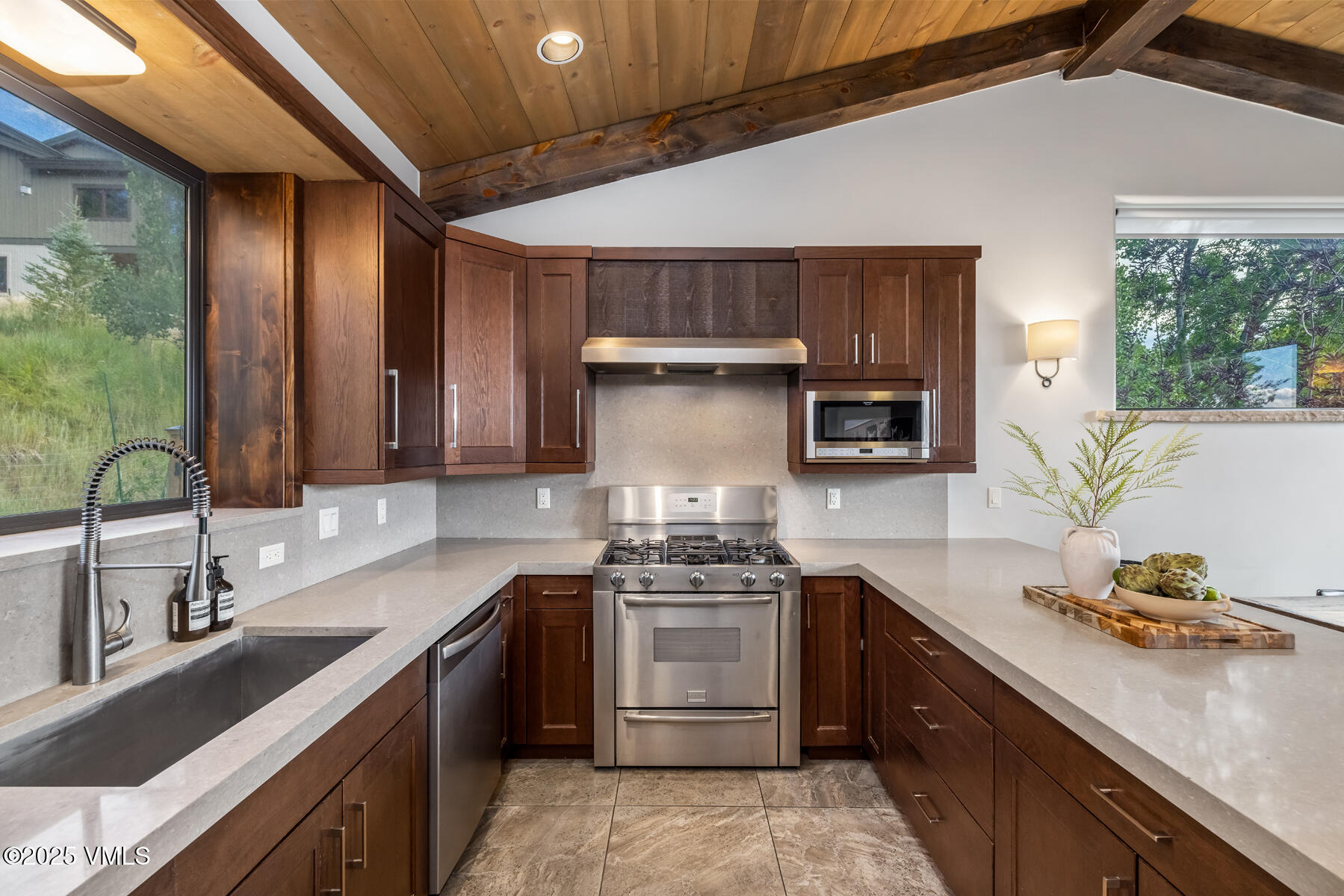 2310 Old Trail Road, Unit A Avon, CO 81620 - Photo 9 of 36 a kitchen with a sink stove and cabinets
