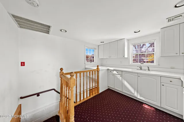 a kitchen with sink cabinets and window