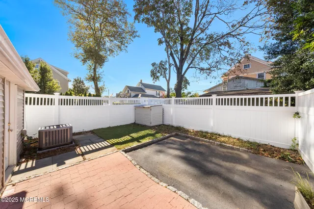 a view of a bench in a back yard of a house