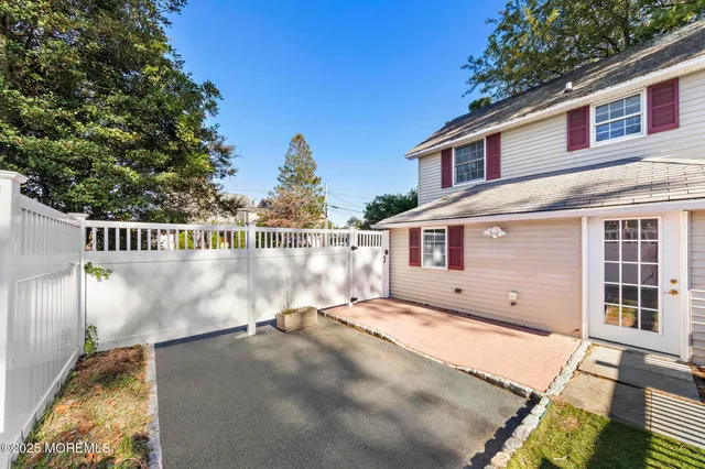 a view of a house with a wooden fence