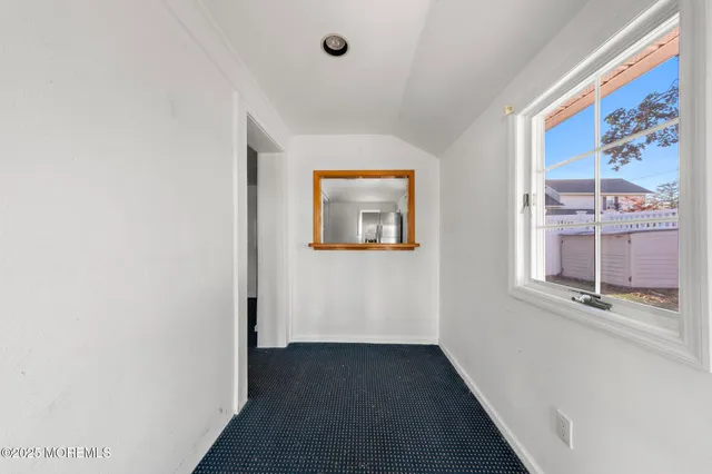 a view of a hallway with a room