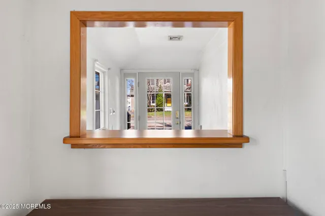 a view of a small space with wooden floor and a window