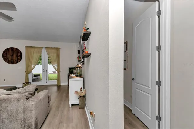 a bedroom with a bed and a flat tv screen on wall