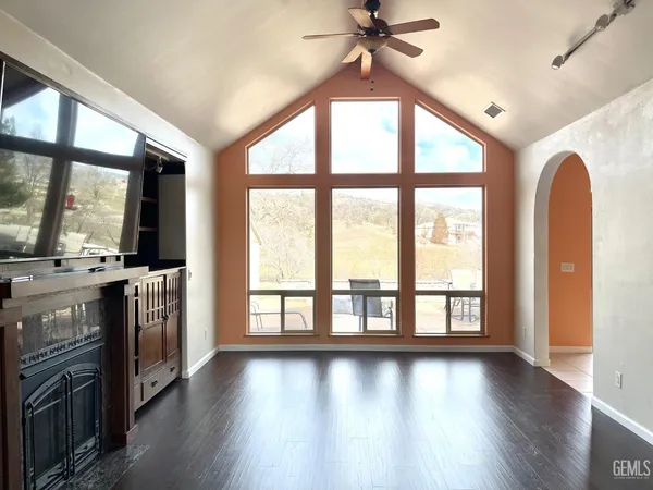 wooden floor in an empty room with a window and wooden floor