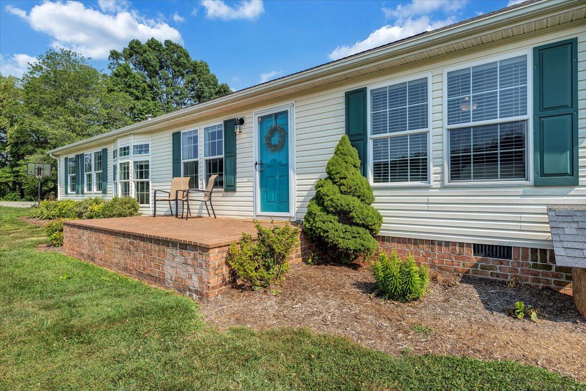 988 Timber Line Road Ferrum, VA 24088 - Photo 2 of 34 a front view of a house with garden and porch