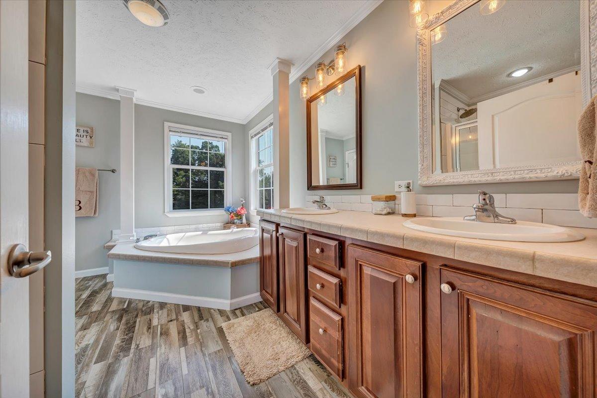 988 Timber Line Road Ferrum, VA 24088 - Photo 17 of 34 a spacious bathroom with a sink double vanity and a bathtub