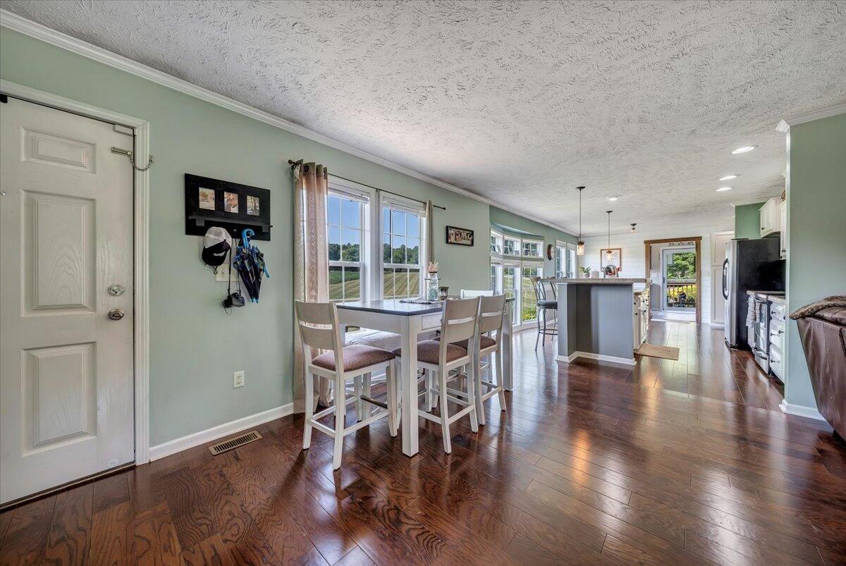 988 Timber Line Road Ferrum, VA 24088 - Photo 6 of 34 a view of a dining room with furniture window and wooden floor
