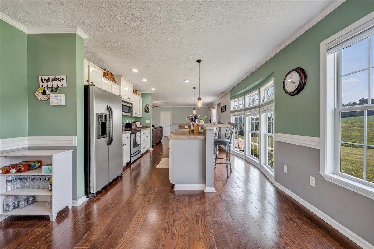 988 Timber Line Road Ferrum, VA 24088 - Photo 9 of 34 a view of a kitchen with fridge and wooden floor
