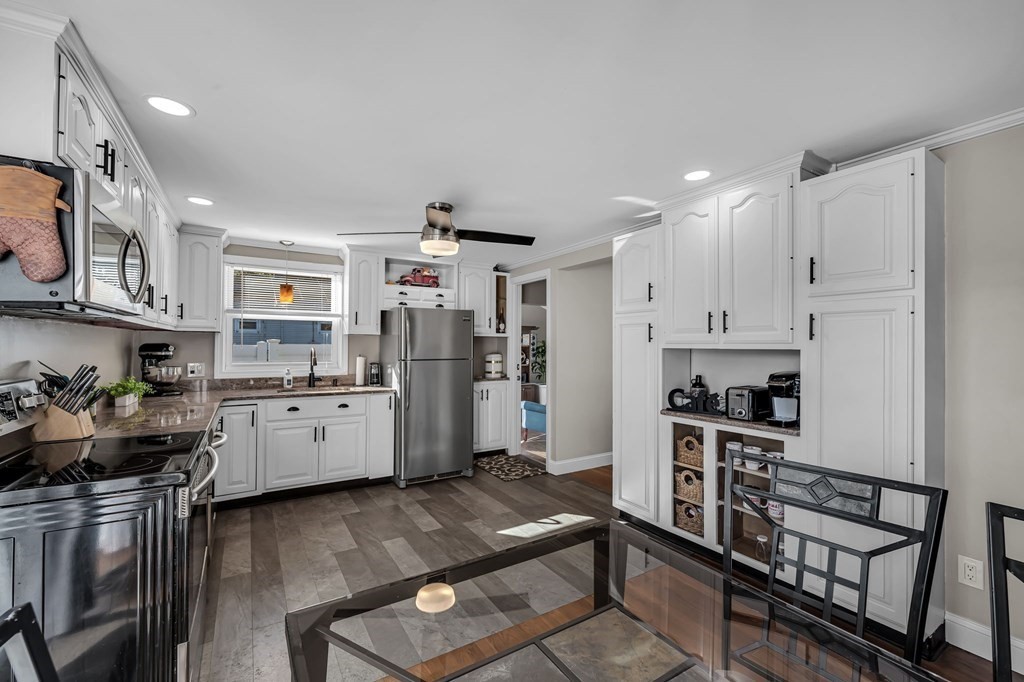 39 Rita Street Springfield, MA 01118 - Photo 11 of 42 a kitchen with stainless steel appliances granite countertop a refrigerator stove top oven and sink