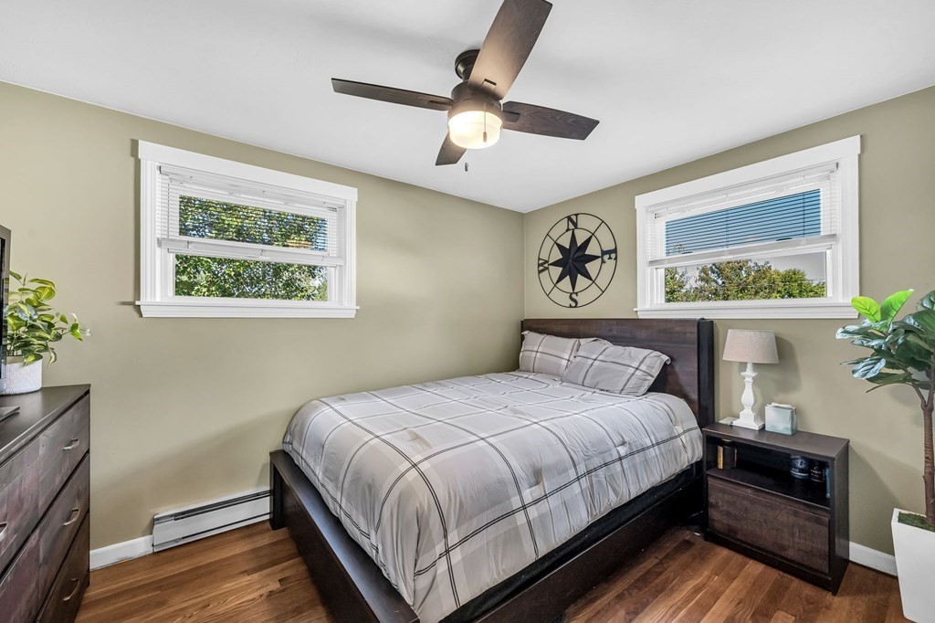 39 Rita Street Springfield, MA 01118 - Photo 18 of 42 a bedroom with a large bed and a chandelier
