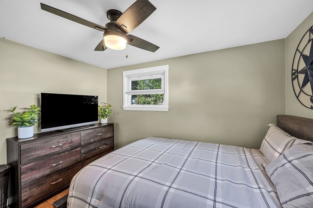 39 Rita Street Springfield, MA 01118 - Photo 19 of 42 a bedroom with a bed and a flat screen tv