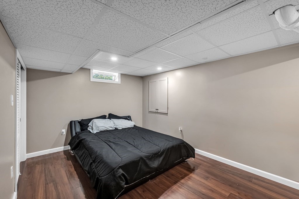 39 Rita Street Springfield, MA 01118 - Photo 28 of 42 a bedroom with a bed and wooden floor