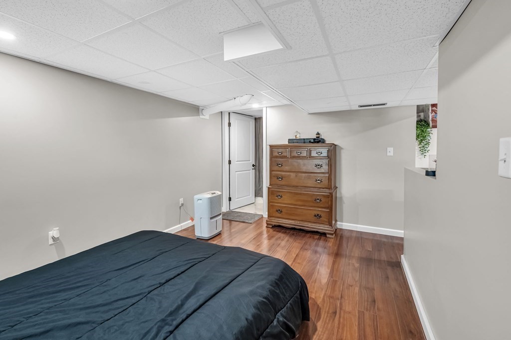 39 Rita Street Springfield, MA 01118 - Photo 29 of 42 a bedroom with a bed and wooden floor