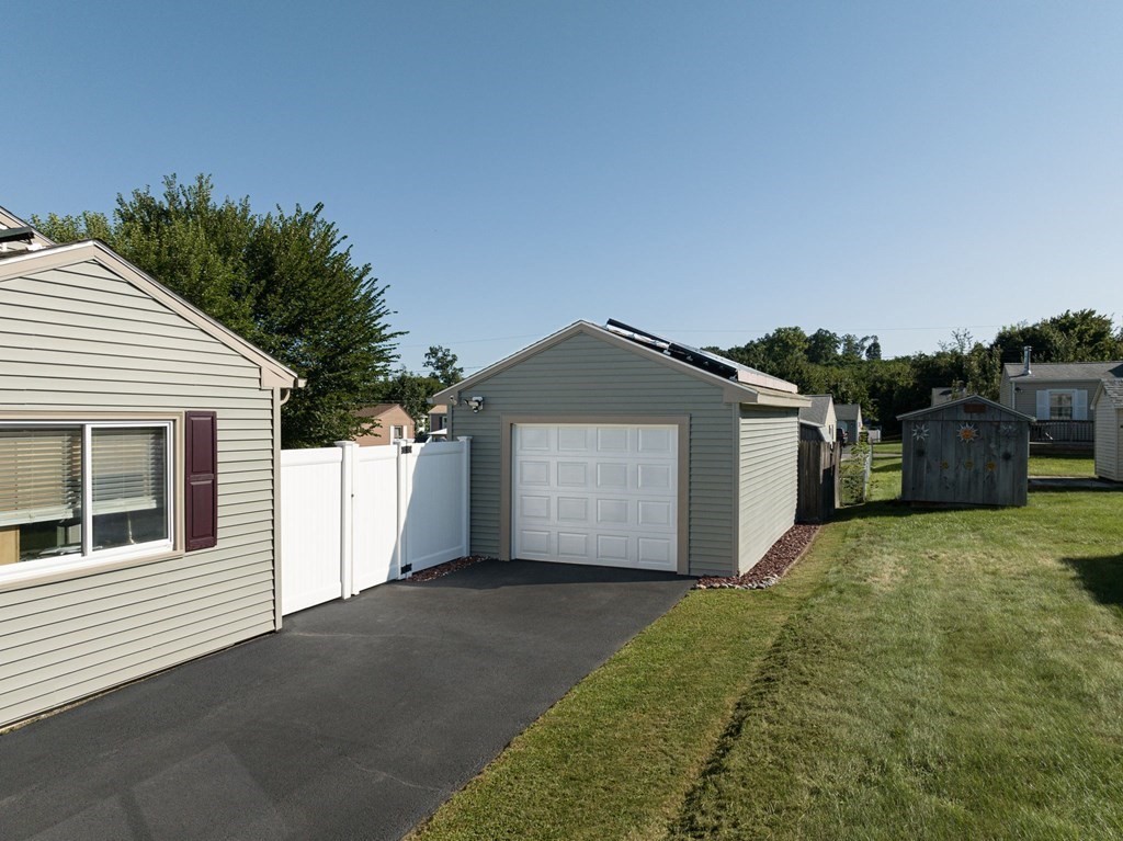 39 Rita Street Springfield, MA 01118 - Photo 39 of 42 a front view of a house with a yard and garage