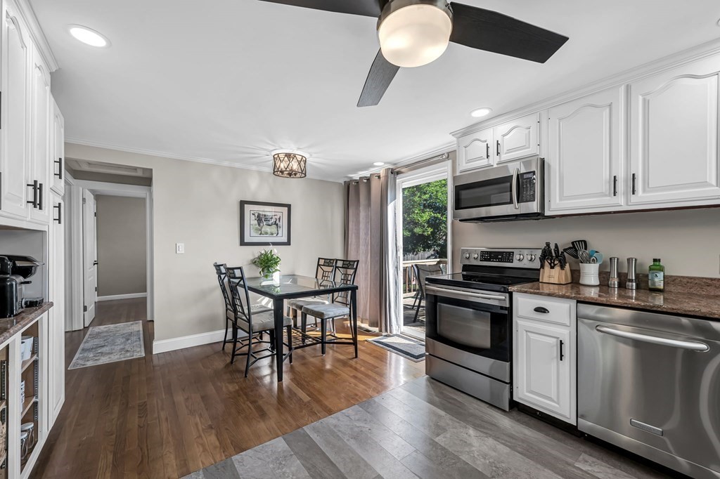 39 Rita Street Springfield, MA 01118 - Photo 8 of 42 a kitchen with stainless steel appliances a white table chairs and a stove