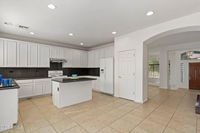a kitchen with a sink and a refrigerator