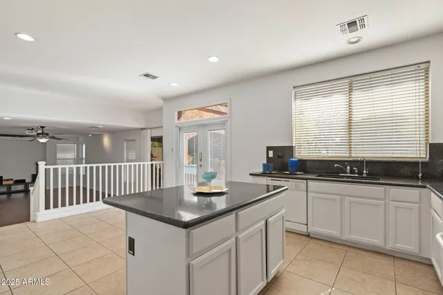 a kitchen with stainless steel appliances granite countertop a sink and cabinets