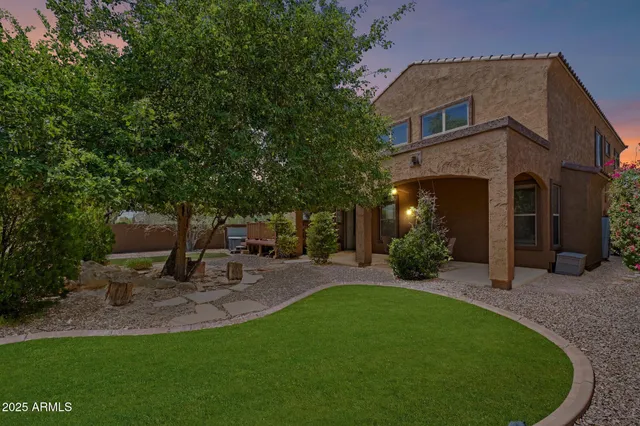 an aerial view of multiple houses with a yard