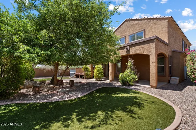 a view of a chair and table in the backyard