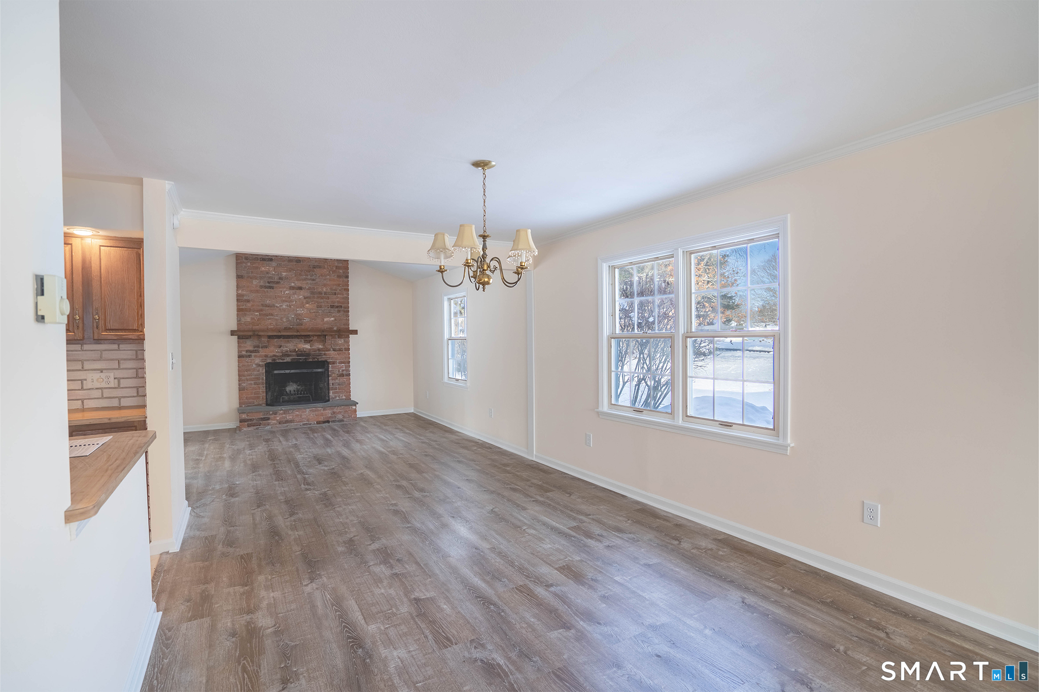 4 Currycross Road, Unit 4 Madison, CT 06443 - Photo 4 of 30 an empty room with windows fireplace and wooden floor