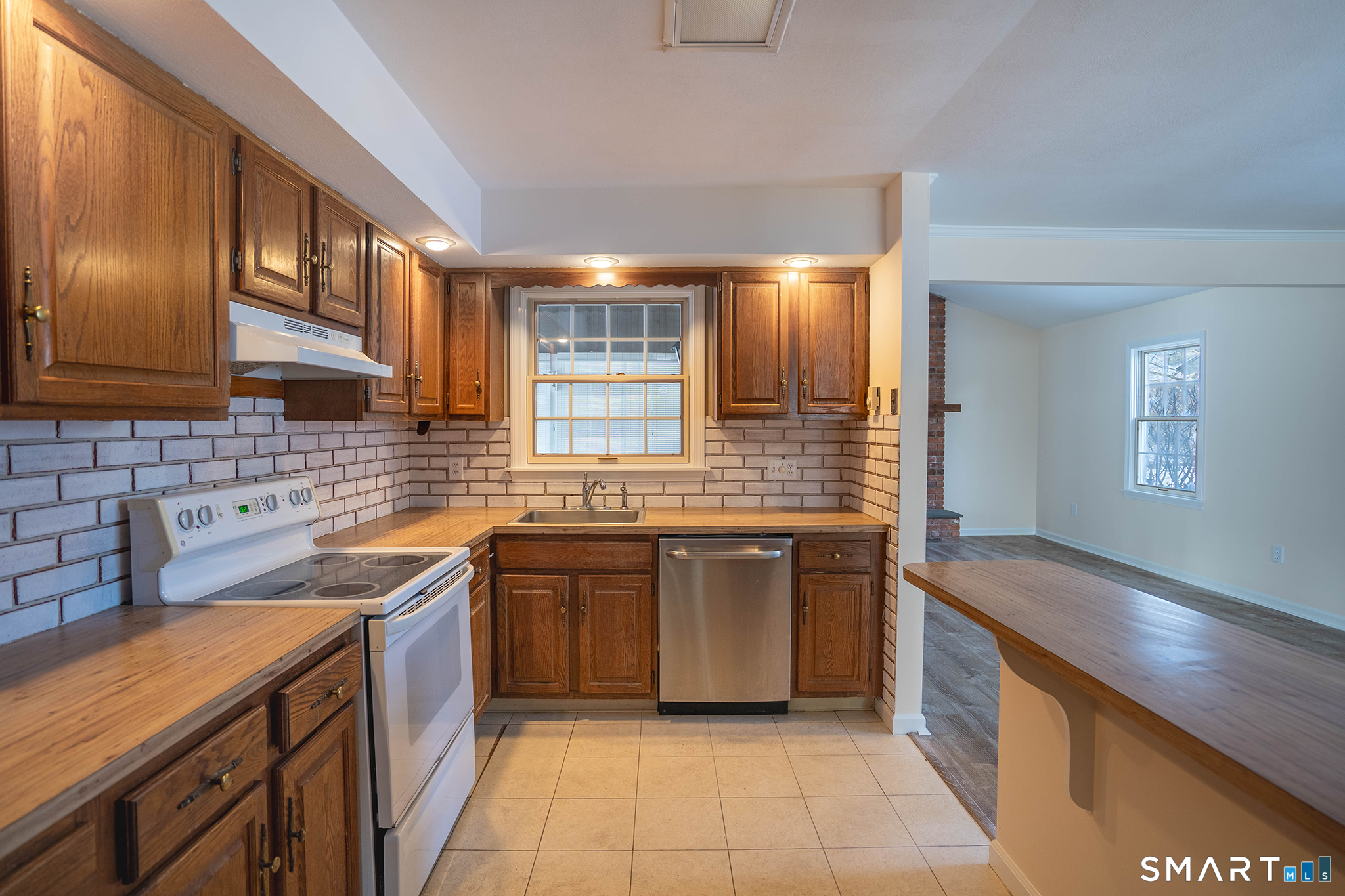 4 Currycross Road, Unit 4 Madison, CT 06443 - Photo 6 of 30 a kitchen with stainless steel appliances granite countertop a sink stove and cabinets
