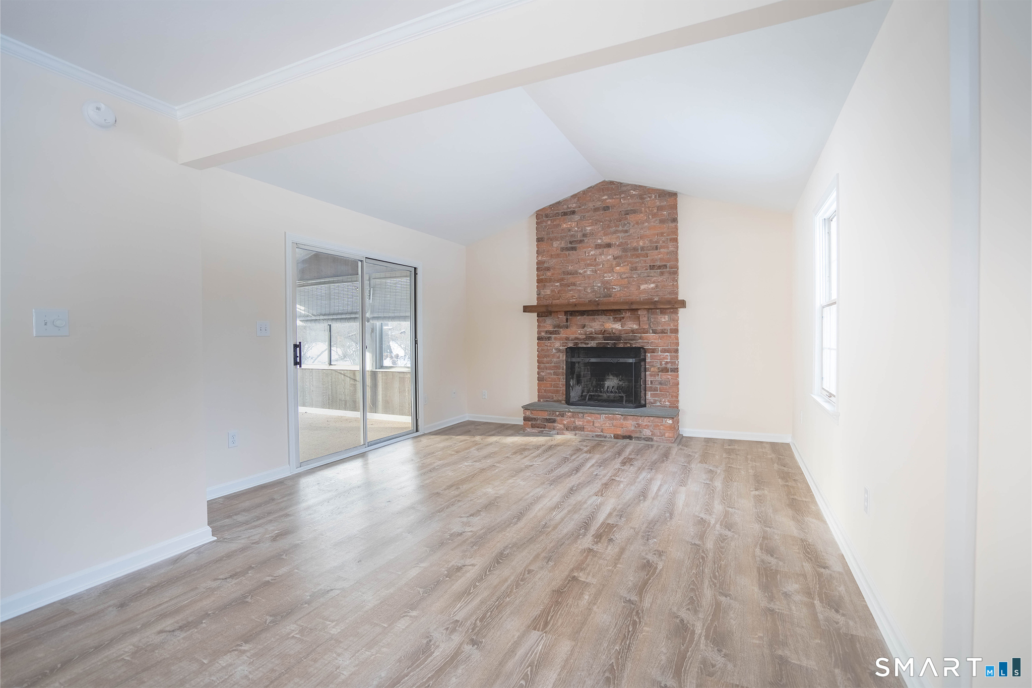 4 Currycross Road, Unit 4 Madison, CT 06443 - Photo 9 of 30 an empty room with windows and fireplace