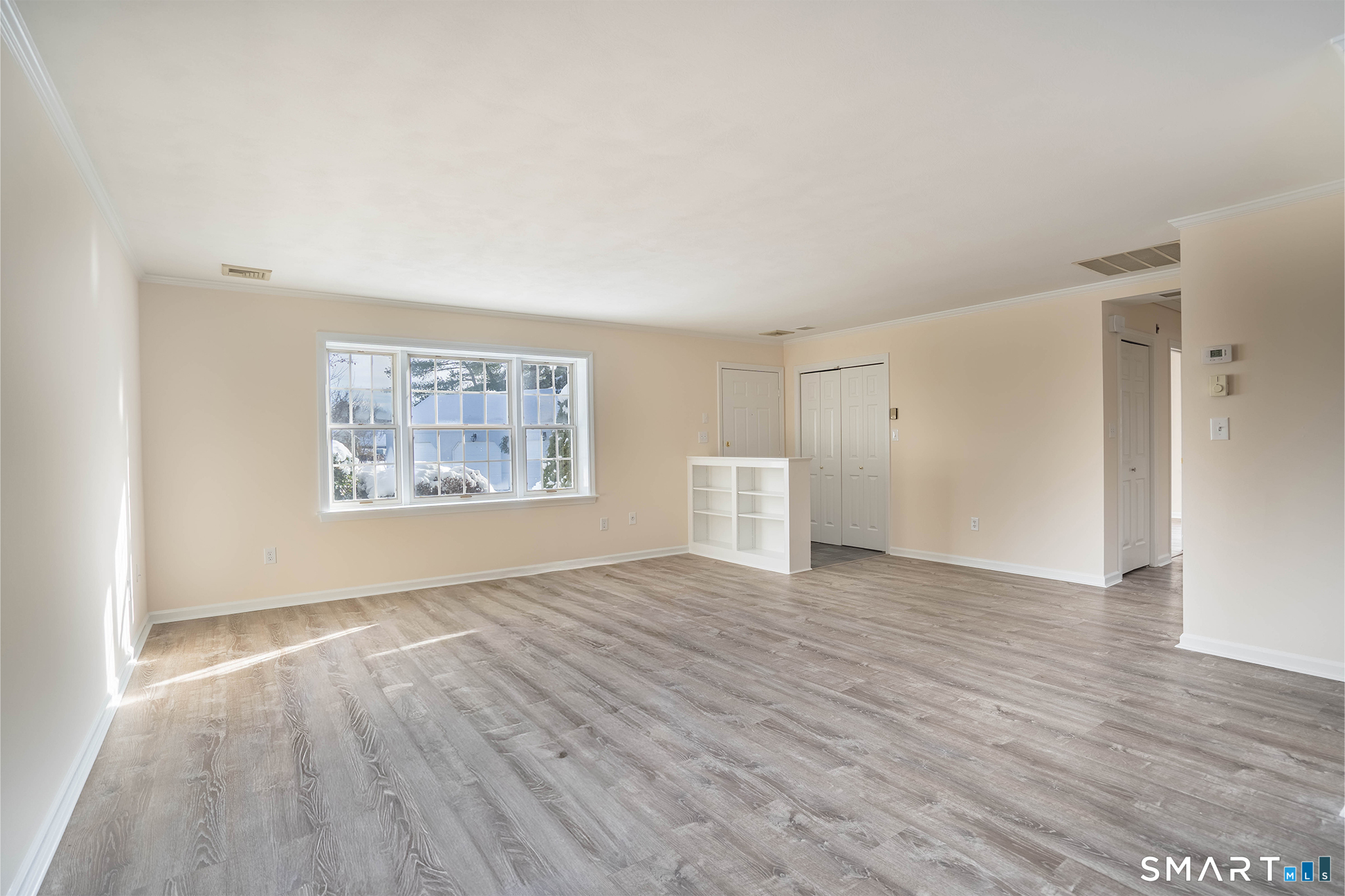 4 Currycross Road, Unit 4 Madison, CT 06443 - Photo 10 of 30 a view of an empty room with wooden floor and a window