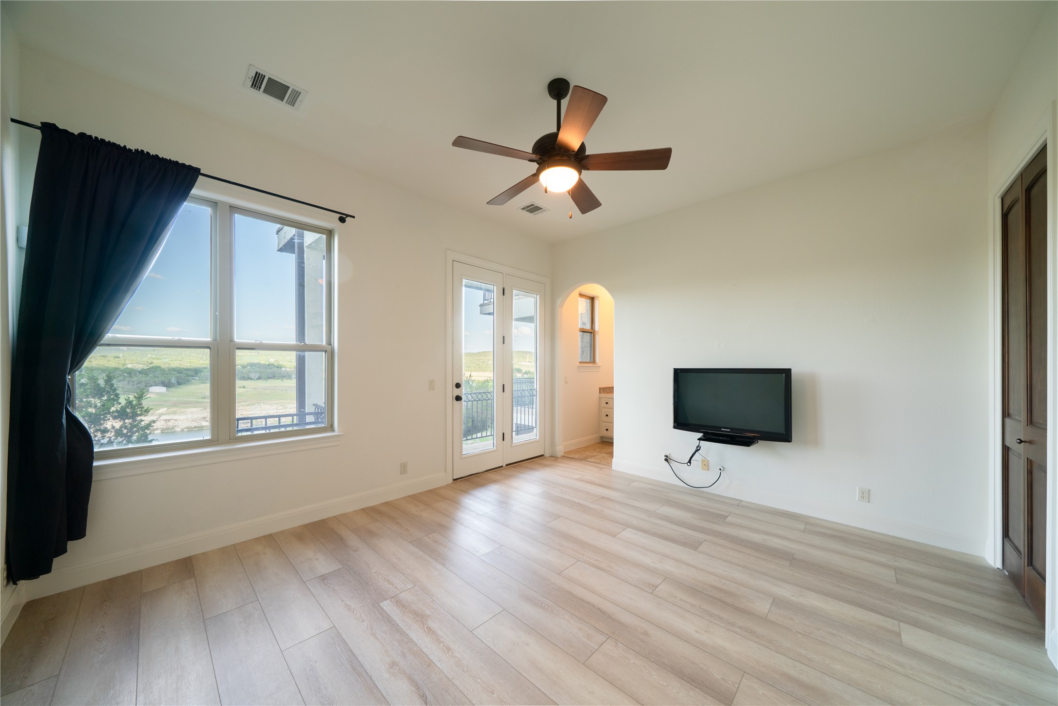 17545 West Reed Park Road, Unit 2 Jonestown, TX 78645 - Photo 30 of 39 a view of an empty room with wooden floor and a window