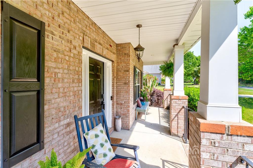1842 Sam Smith Road Fort Mill, SC 29708 - Photo 3 of 28 a view of a patio with table and chairs potted plants near floor to ceiling window