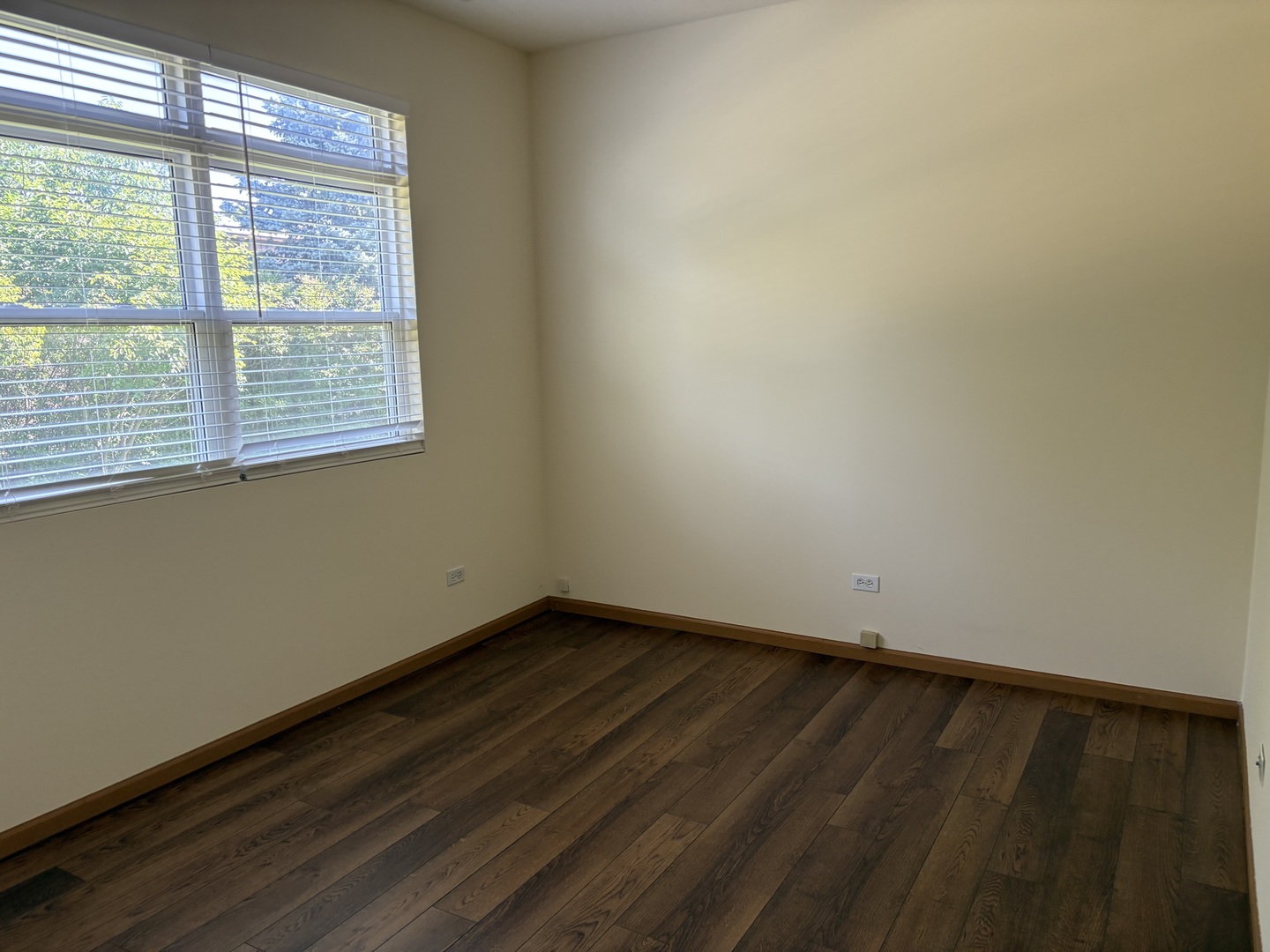 7207 Bradley Drive Plainfield, IL 60586 - Photo 11 of 12 a view of an empty room with wooden floor and a window