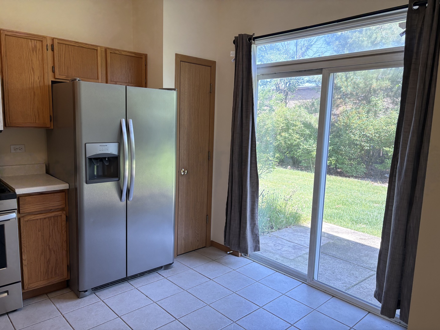 7207 Bradley Drive Plainfield, IL 60586 - Photo 4 of 12 a metallic refrigerator freezer sitting in a kitchen