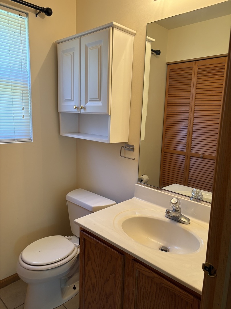 7207 Bradley Drive Plainfield, IL 60586 - Photo 5 of 12 a bathroom with a sink toilet and mirror