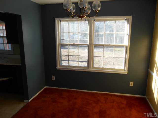 907 Wyldewood Road Durham, NC 27704 - Photo 5 of 9 a view of an empty room with a window