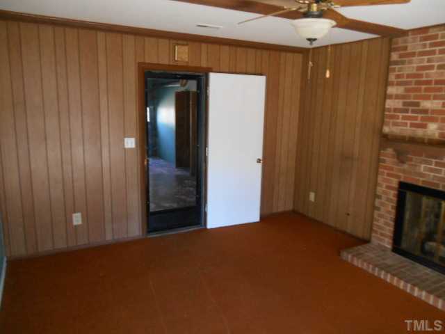 907 Wyldewood Road Durham, NC 27704 - Photo 9 of 9 a view of empty room with a fireplace
