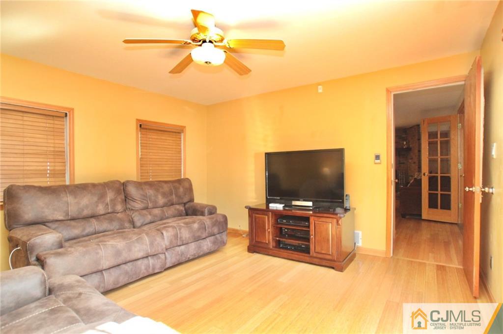 386 East Pleasant Grove Road Jackson, NJ 08527 - Photo 11 of 24 a living room with furniture and a flat screen tv