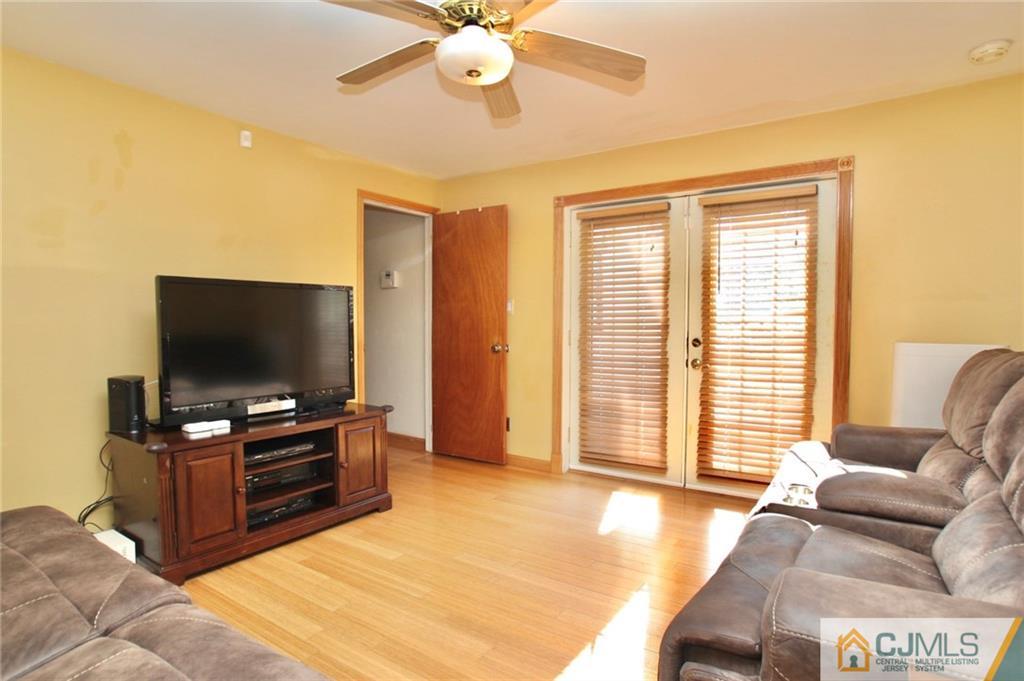 386 East Pleasant Grove Road Jackson, NJ 08527 - Photo 12 of 24 a living room with furniture and a flat screen tv