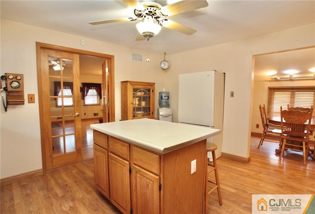 386 East Pleasant Grove Road Jackson, NJ 08527 - Photo 15 of 24 a kitchen that has a table chairs and wooden floor
