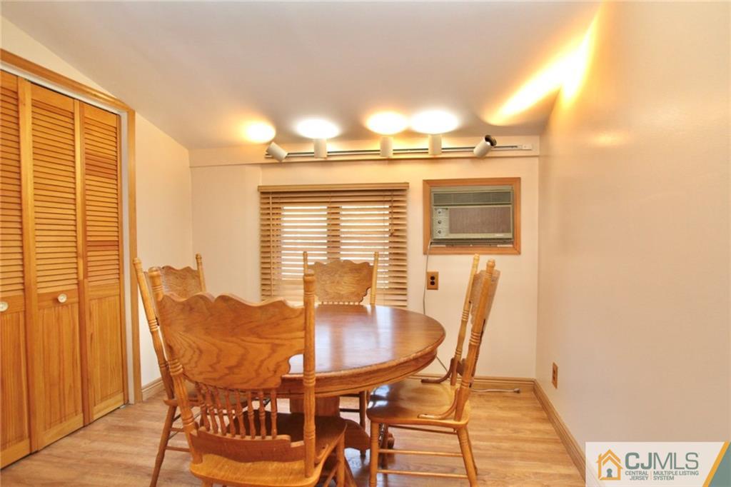 386 East Pleasant Grove Road Jackson, NJ 08527 - Photo 17 of 24 a view of a dining room with furniture and wooden floor