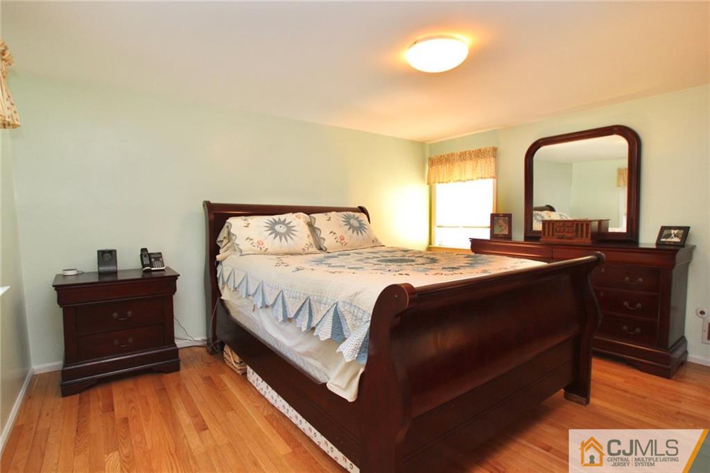 386 East Pleasant Grove Road Jackson, NJ 08527 - Photo 18 of 24 a spacious bedroom with a bed and a dresser