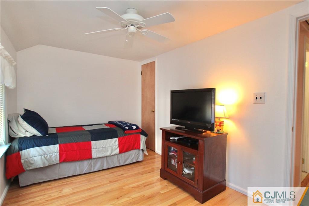 386 East Pleasant Grove Road Jackson, NJ 08527 - Photo 19 of 24 a living room with furniture and a flat screen tv