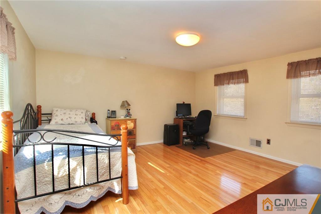 386 East Pleasant Grove Road Jackson, NJ 08527 - Photo 22 of 24 a bedroom with a bed and a desk