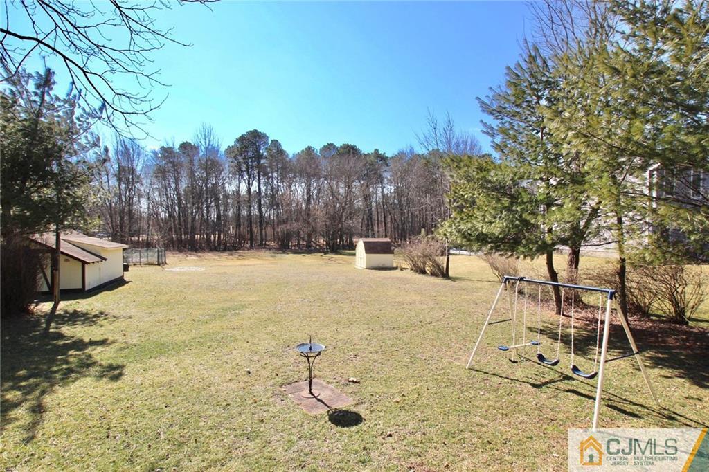 386 East Pleasant Grove Road Jackson, NJ 08527 - Photo 5 of 24 a view of a yard with a tree