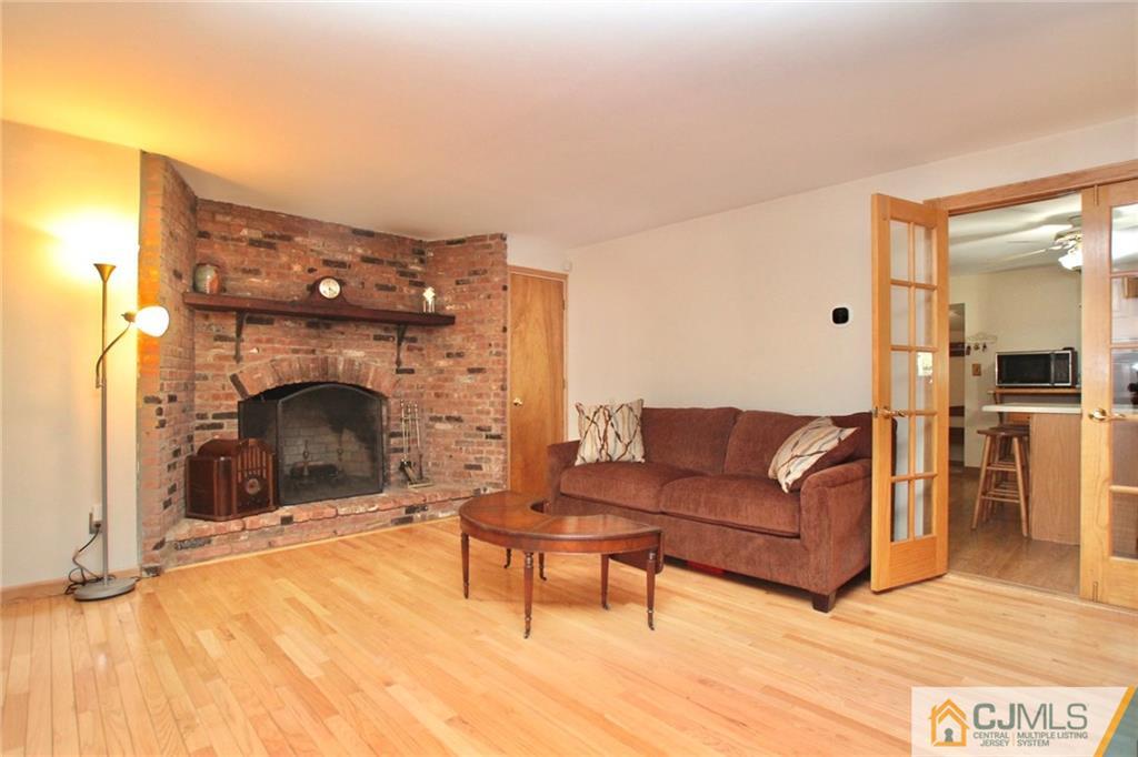 386 East Pleasant Grove Road Jackson, NJ 08527 - Photo 7 of 24 a living room with furniture and a fireplace