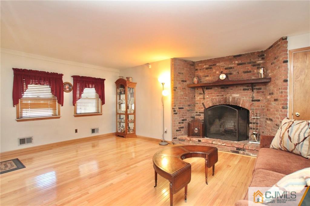 386 East Pleasant Grove Road Jackson, NJ 08527 - Photo 8 of 24 a bedroom with furniture and a fireplace