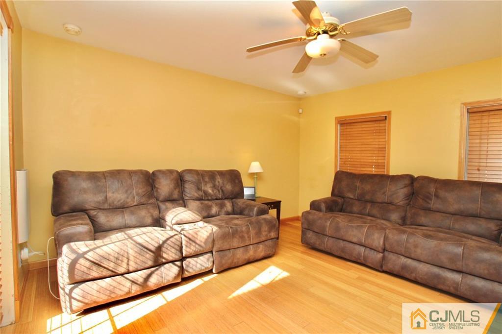 386 East Pleasant Grove Road Jackson, NJ 08527 - Photo 10 of 24 a living room with a couch and a ceiling fan